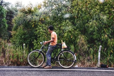 Rear view of man sitting on bicycle