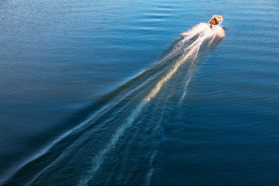 Boat trail at water surface . moving motorboat