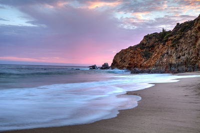 Scenic view of beach against sky during sunset