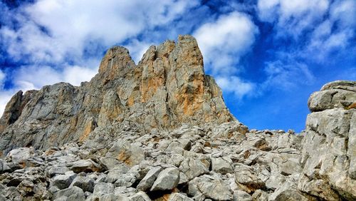 Low angle view of rocky mountains against sky