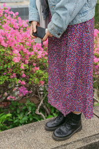 Low section of woman standing on field