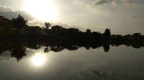 Scenic view of lake against sky during sunset