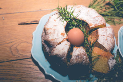 High angle view of babka with easter egg in plate on table