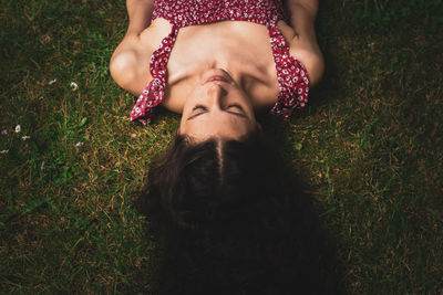 High angle view of woman lying down on land