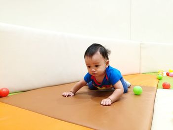 Boy playing on table at home