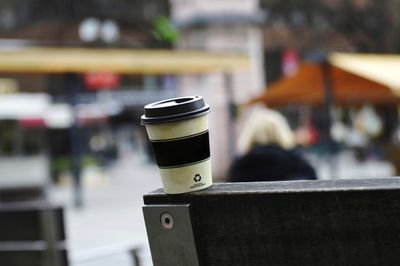 Close-up of drink on table by railing