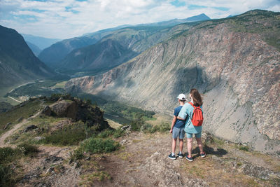 Rear view of people looking at mountains