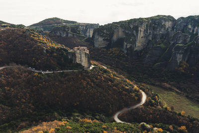 Aerial view of building on rock mountains against sky