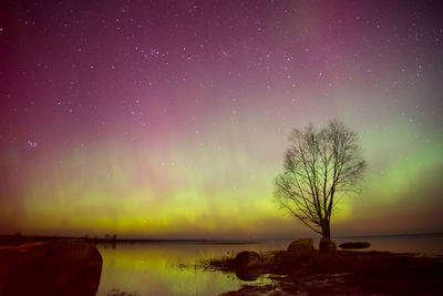 Scenic view of lake against sky at night