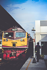 Man standing on train against sky