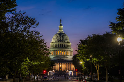 Low angle view of illuminated building against sky at night