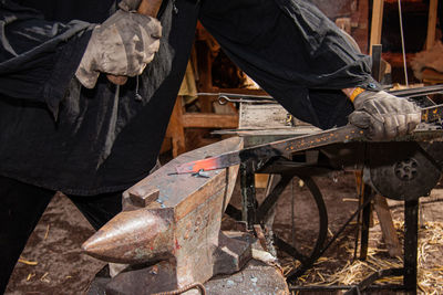 Low section of man working on wood