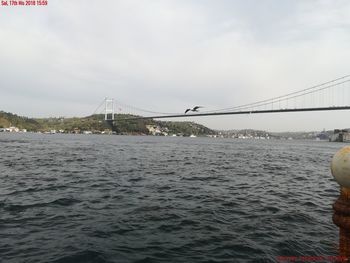 View of suspension bridge over sea