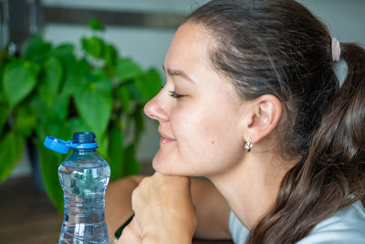 Close-up of young woman drinking water