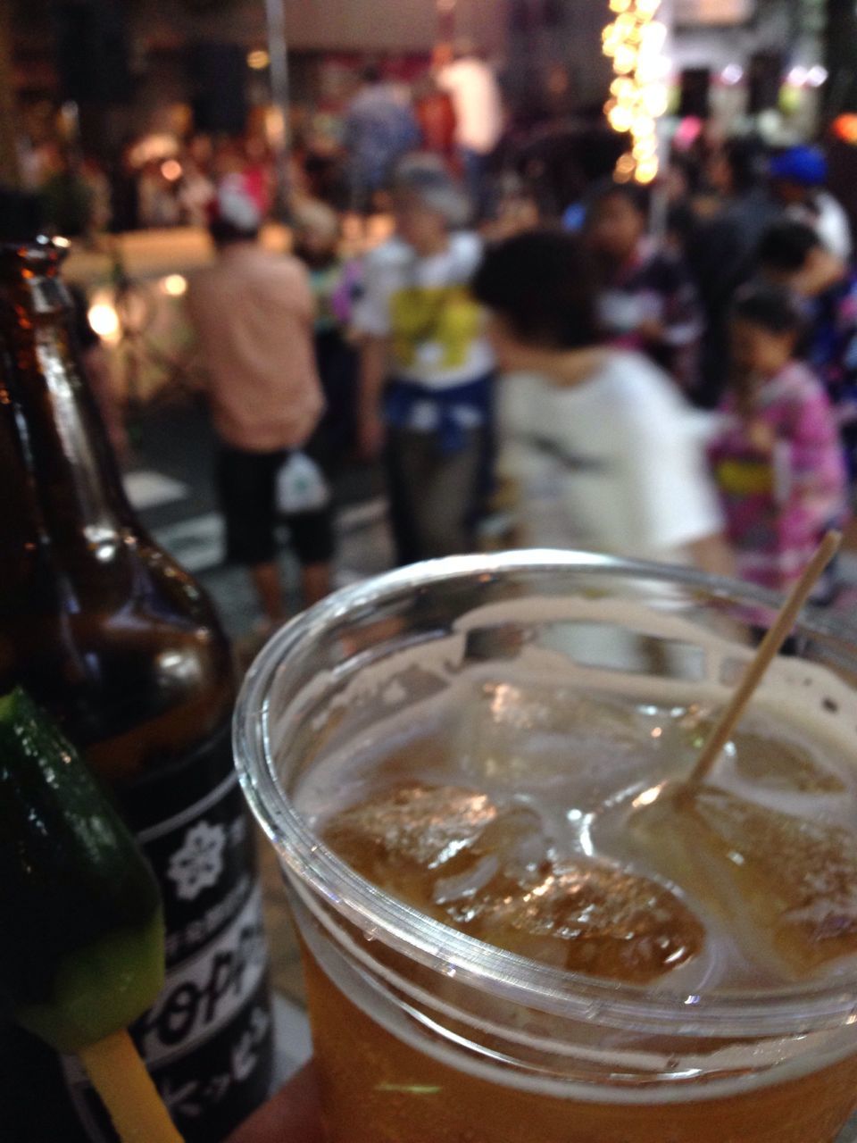 food and drink, drink, refreshment, freshness, indoors, drinking glass, focus on foreground, incidental people, close-up, table, restaurant, glass - material, alcohol, person, selective focus, lifestyles, men, indulgence, transparent