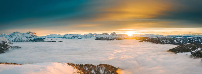 Scenic view of snow covered mountains against sky during sunset