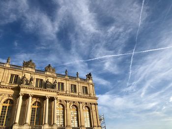 Low angle view of building against cloudy sky