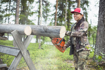 Woman using chainsaw