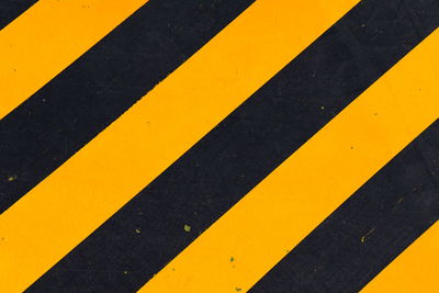 High angle view of yellow arrow sign on road