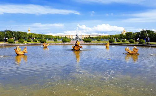 Scenic view of fountain against cloudy sky