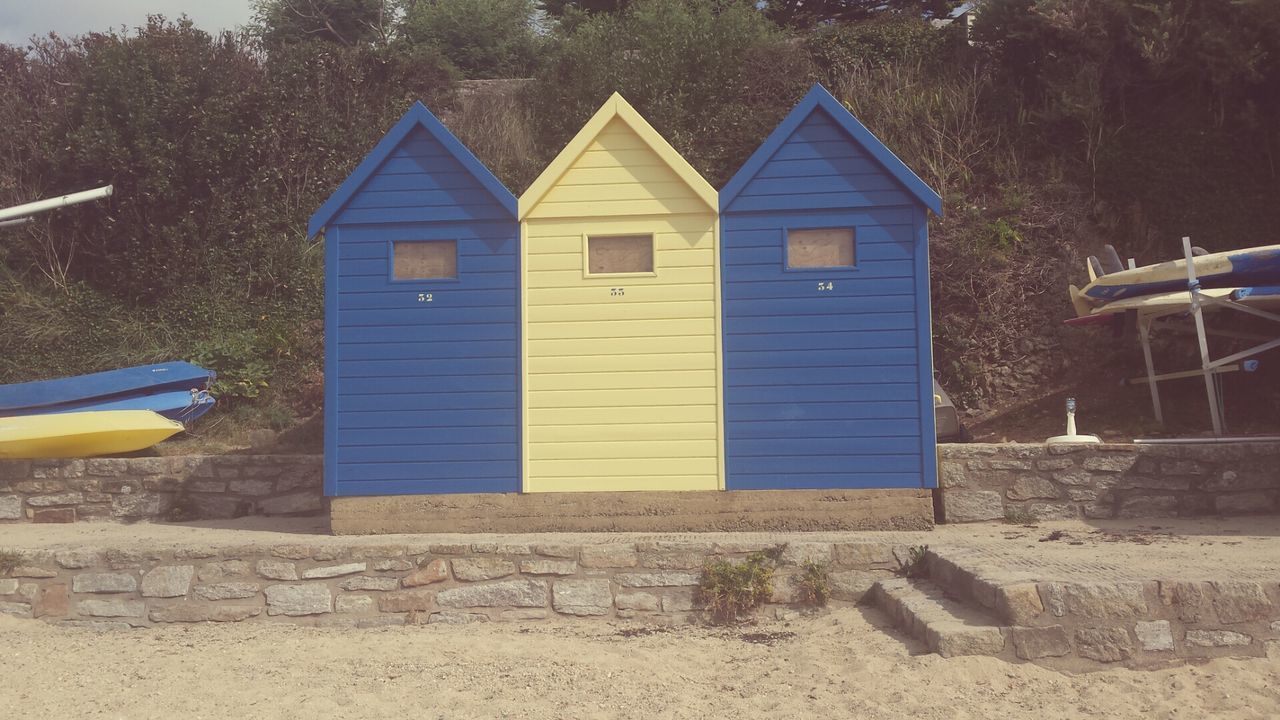 building exterior, built structure, architecture, blue, multi colored, day, tree, house, outdoors, no people, transportation, protection, yellow, sunlight, water, absence, wall - building feature, nature, green color, sky