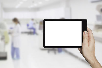Low section of person holding mobile phone
