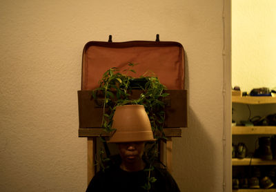 Boy in plant against wall