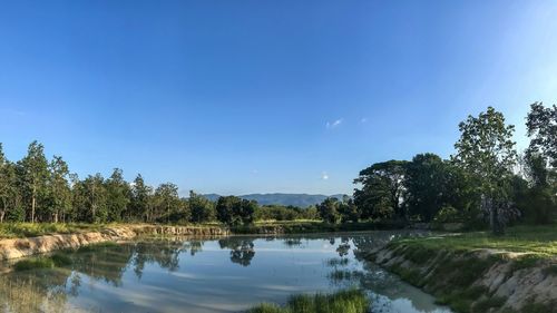 Scenic view of lake against blue sky