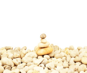 Stack of pebbles against white background