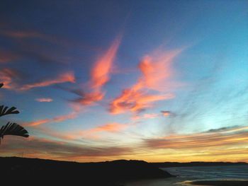 Dramatic sky over silhouette landscape