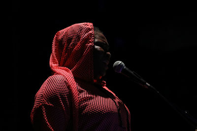 Full length portrait of man against black background