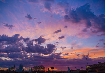 Low angle view of silhouette buildings against sky during sunset