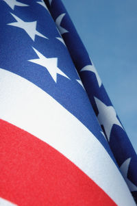 Low angle view of flags against blue sky