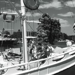 Boats at lake against sky