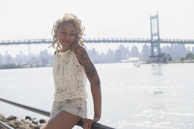 Woman looking at bridge over river