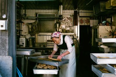 Woman working in kitchen at store