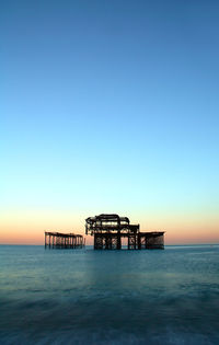 Scenic view of sea against clear sky at sunset