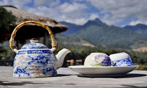 Figurine on mountain against sky