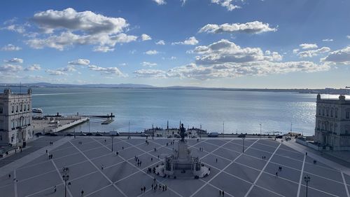 High angle view of sea by city against sky