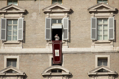 Full length of man on red building