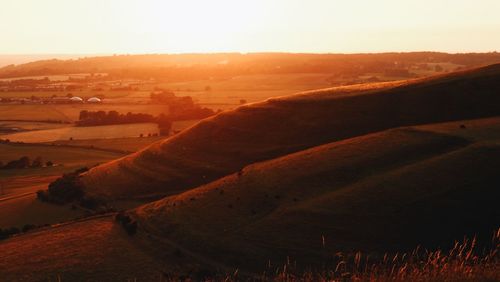 Scenic view of field against sky during sunset