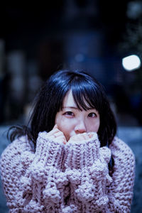 Close-up portrait of young woman in snow