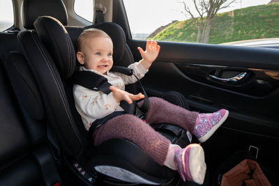 Portrait of smiling young woman in car