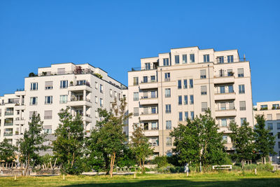 Residential buildings against clear blue sky