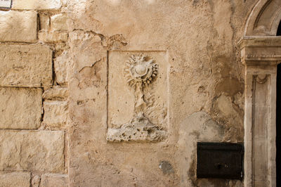 Close-up of carving on wall of building