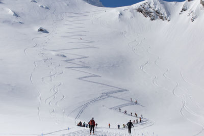 High angle view of people skiing on snowcapped mountain