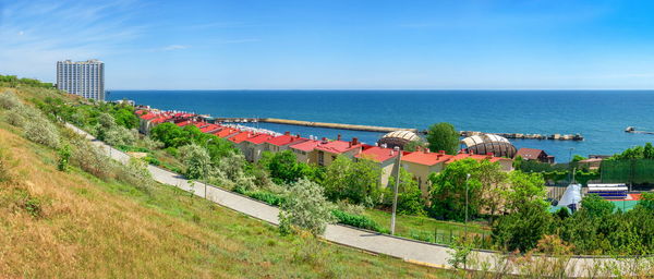 Scenic view of sea by buildings against sky