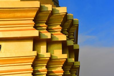 Low angle view of stack against blue sky