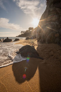 Scenic view of beach against sky during sunset