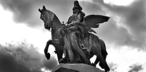 Low angle view of statue against cloudy sky